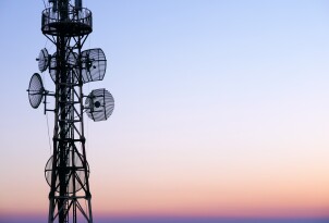 Telecommunication tower Antenna at sunset sky.