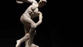 Discus thrower discobolo statue isolated on black