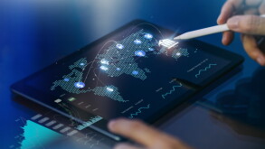 Person working on screen with financial graphs and overlaid network
