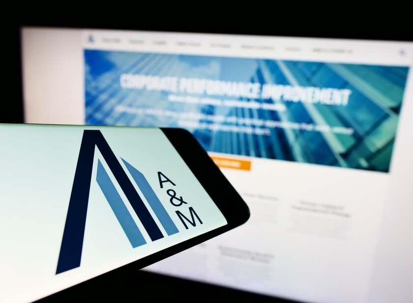 Stuttgart, Germany - 06-19-2022: Cellphone with logo of American consulting company Alvarez and Marsal LLC on screen in front of website. Focus on center-right of phone display.