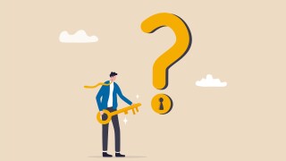 Key to unlock answer for problem and questions, solution or reason to solve problem, wisdom or understanding concept, smart businessman holding golden key to unlock keyhole on question mark sign.