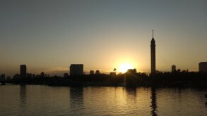 Scenic View Of River And Buildings Against Sky During Sunset