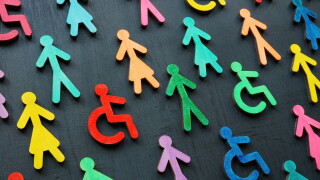 Diversity and inclusion concept. Colorful figurines on the dark surface.