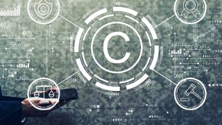 Copyright concept with businessman holding a tablet