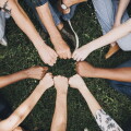 Diverse people doing a fist bump in the park