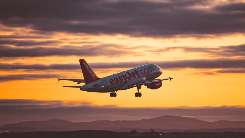 EasyJet airplane a320 flying in the sky at sunset