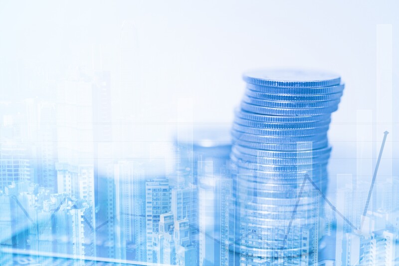 Double exposure of stacks of coins and account book or credit card with financial graph and city background, finance and business concept.