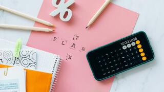 Calculator, pencils, and paper with "tax plan" on it