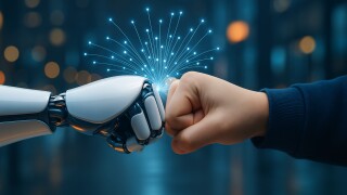 Robot and human hands making a fist bump, symbolizing future collaboration, partnership, and successful teamwork between people and AI.