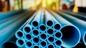 Close up to blue plastic pipe background, PVC pipes stacked in warehouse,  PVC water pipes used for construction