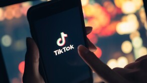 Tik Tok application icon on iPhone 11 pro max screen in hand and
