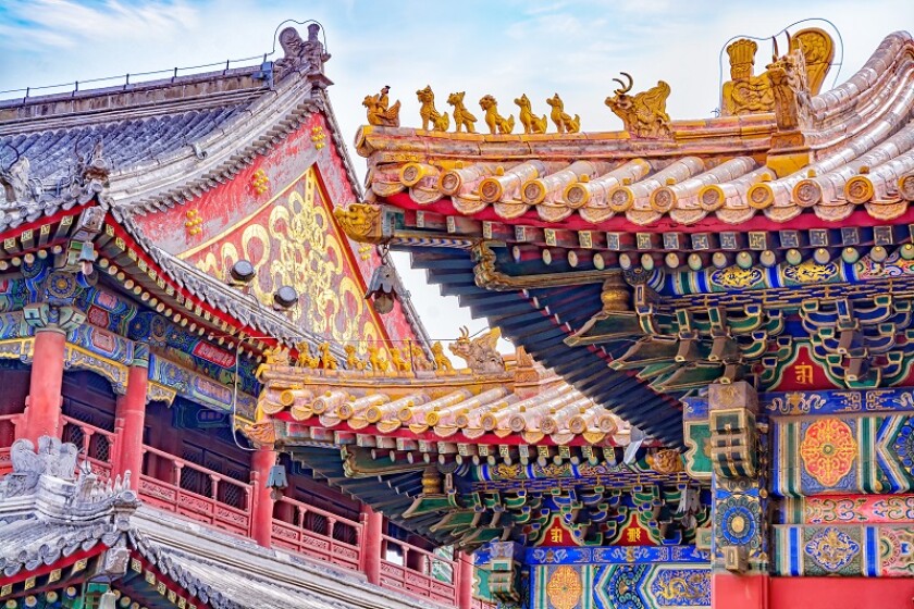 Chinese traditional architecture -  colorful ornament and statue dragons on roof of Lama Temple in Beijing, China