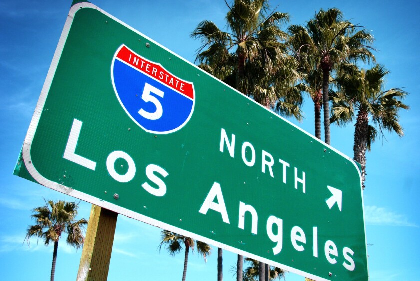 Los Angeles freeway sign with palm trees