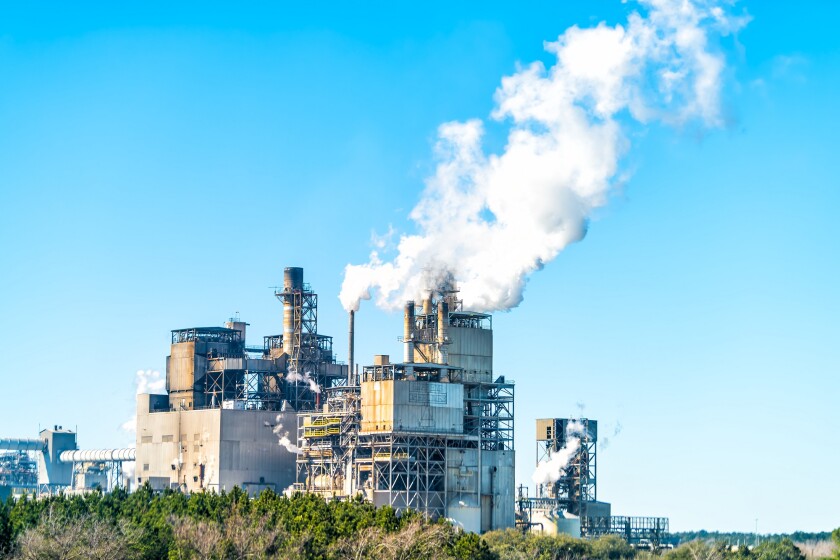 Industrial paper mill factory plant with chimney smokestacks sta