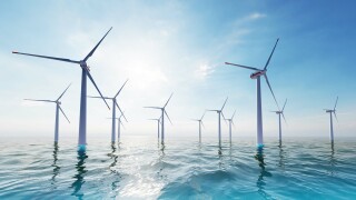 Ocean Wind Farm. Windmill farm in the ocean. Offshore wind turbines in the sea. Wind turbine from aerial view