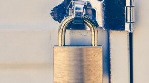 Close - up Metal padlock and metal white door