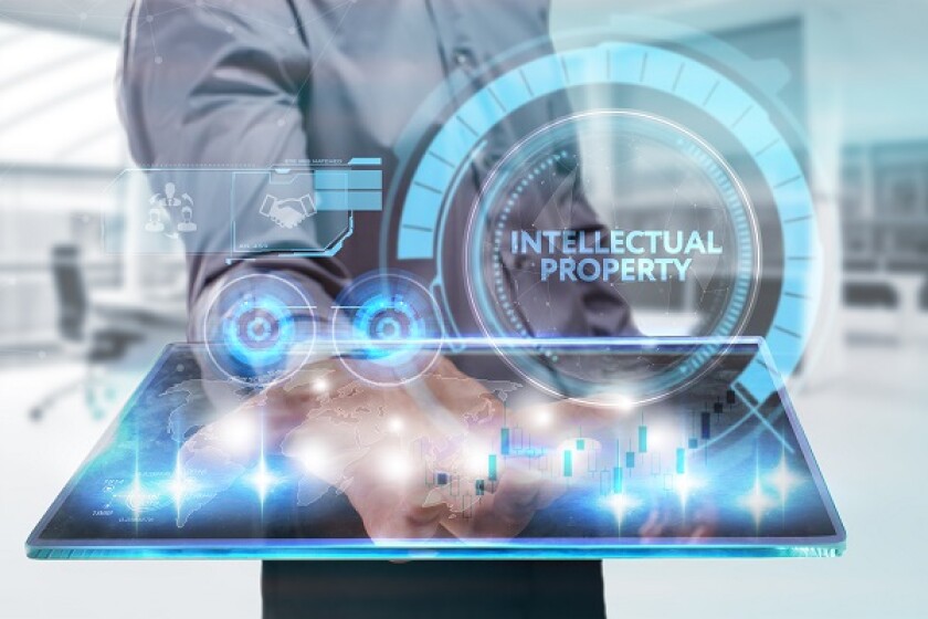 The concept of business, technology, the Internet and the network. A young entrepreneur working on a virtual screen of the future and sees the inscription: Intellectual property