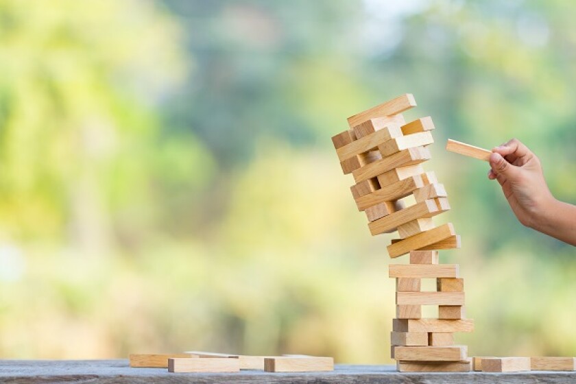 The jenga game ,tower stack from wooden blocks toy and  hand tak