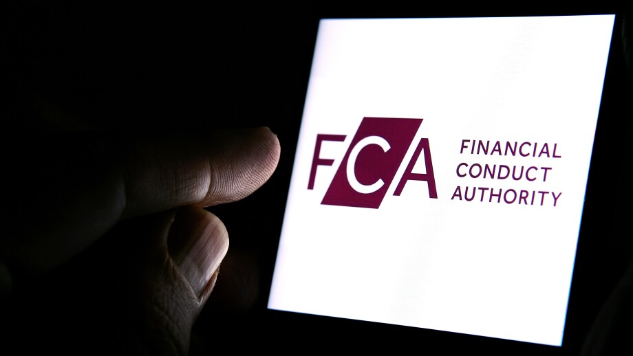 FCA Financial Conduct Authority logo on the smartphone and finger pointing at it in the dark room. Concept.  FCA is a financial regulatory body in the United Kingdom.