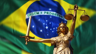 Lady of Justice against a background of the Brazilian flag