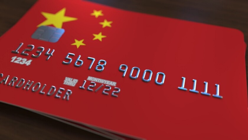 Plastic bank card featuring flag of China. National banking system related 3D rendering