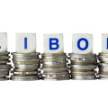 Stacks of coins with the letters LIBOR isolated on white