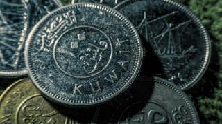 Coins of dinars, Kuwait national currency and lines from the Quran