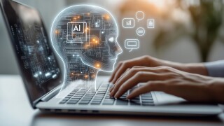 Person uses laptop interacting with AI virtual assistant. AI head graphic overlay laptop keyboard. Concept of AI prompt engineering, LLM. Person types on keyboard to communicate with virtual