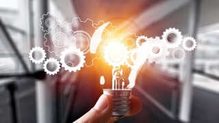 Hand holding light bulb and cog inside. Idea and imagination. Creative and inspiration. Innovation gears icon with network connection on metal texture background. Innovative technology industrial.