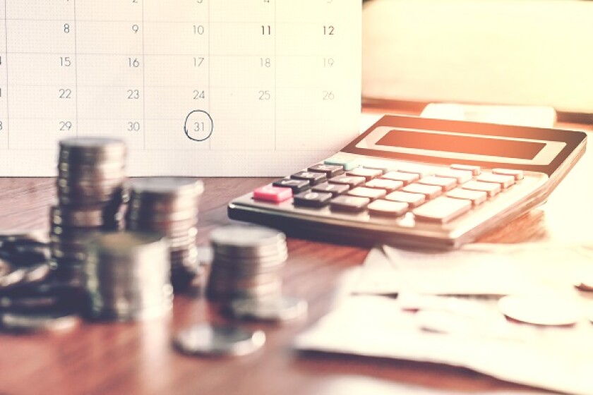  debt collection and tax season concept with deadline calendar remind note,coins,banks,calculator on table, background ,time to pay concept 