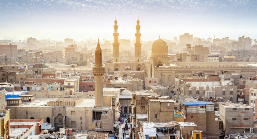 CAIRO, EGYPT - OCTOBER 12, 2018: Panorama of the medieval Bab Zuweila gate located in the heart of Islamic Cairo and surrounded by noisy Arab souq (market), on October 12 in Cairo.