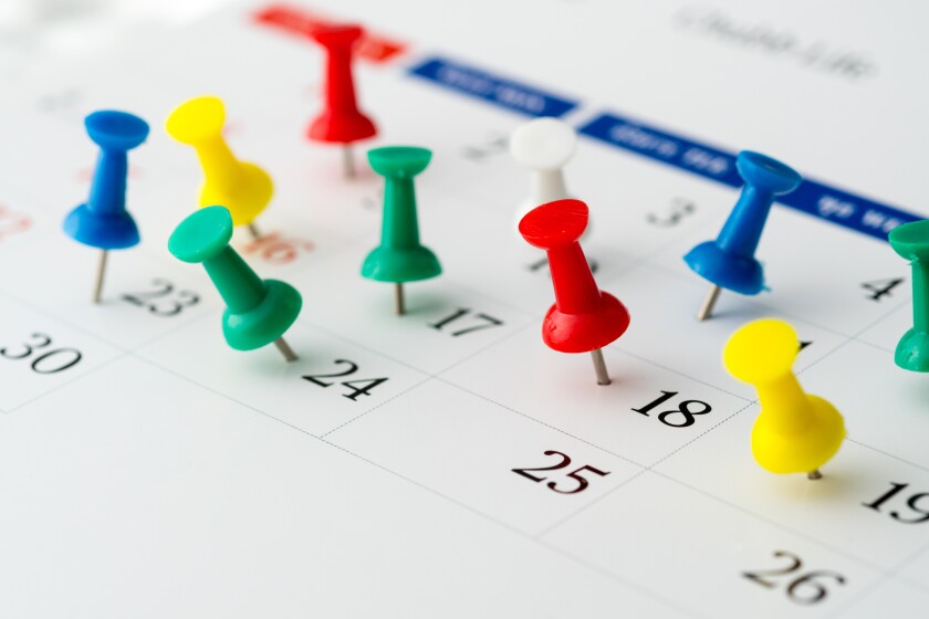 Push pins on calendar. Idea concept of to do planning.