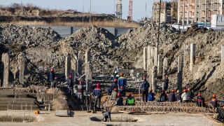 construction site with cranes and workers