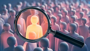 Magnifying glass emphasizing one glowing figure among group symbolizing focused hiring