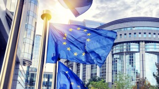 EU flags waving in front of European Parliament building in Brus