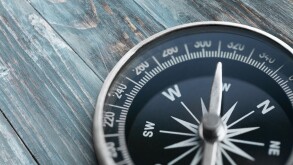 Brass antique compass  on background