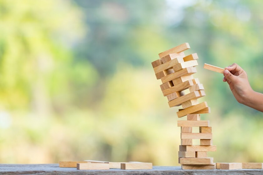 The jenga game ,tower stack from wooden blocks toy and  hand tak