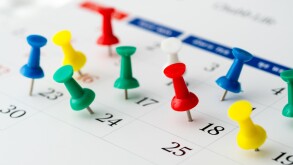 Push pins on calendar. Idea concept of to do planning.