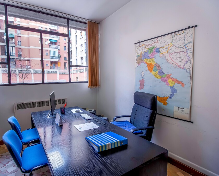 Office room with map of Italy on the wall