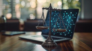 Justice Scales Resting on Open Laptop With Digital Network on Screen