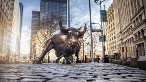 NEW YORK CITY - MARCH 24, 2020: Charging Bull sculpture on March 24, 2020 on empty streets of  New York City during Corona virus Epidemic. 