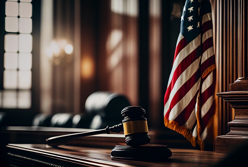 Mallet of judge in American courtroom. American flag in courtroo