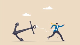 Freedom, relief or escape from bad habit, psychology anchoring effect or cut heavy burden to growing more concept, businessman using scissor to cut the rope tie himself with big heavy anchor.
