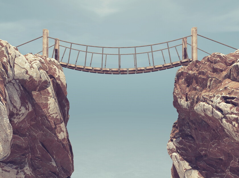 Old bridge over between two big rocks. 