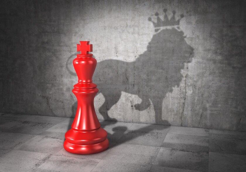 Leader concept. Headman. Chess king cast shadow in form of lion