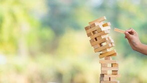 The jenga game ,tower stack from wooden blocks toy and  hand tak