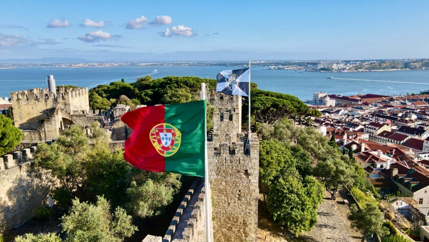 Portuguese skyline with flag at forefront.jpg