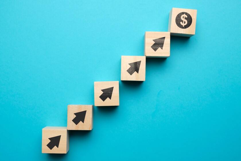 Us dollar growth concept and with icons on wooden blocks.