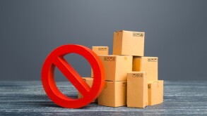 Cardboard boxes and red prohibition symbol NO. Restriction on import, ban on export of dual-use goods to countries under sanctions. Out of stock. Embargo trade wars. Overproduction or scarcity.