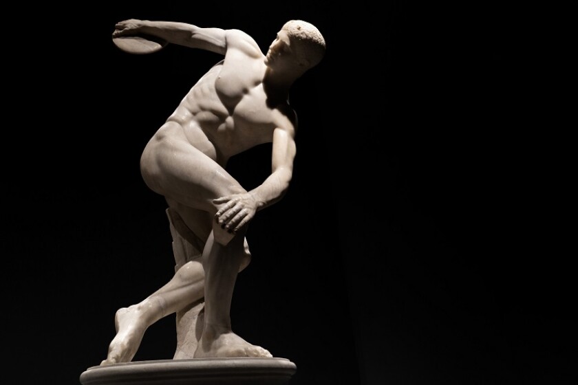 Discus thrower discobolo statue isolated on black